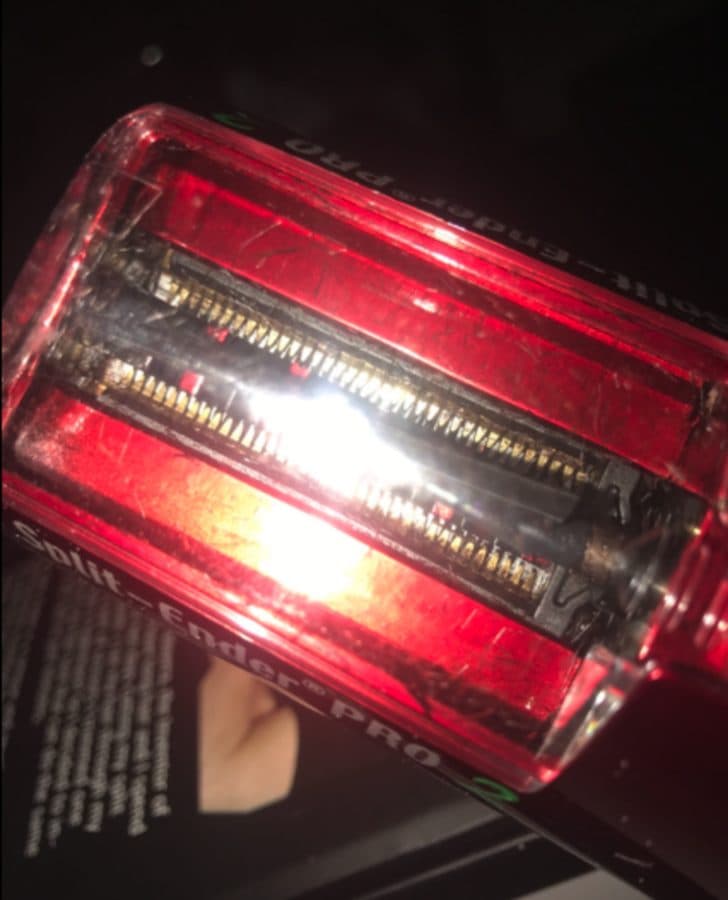 A red Split Ender PRO with removed hair behind the chamber window